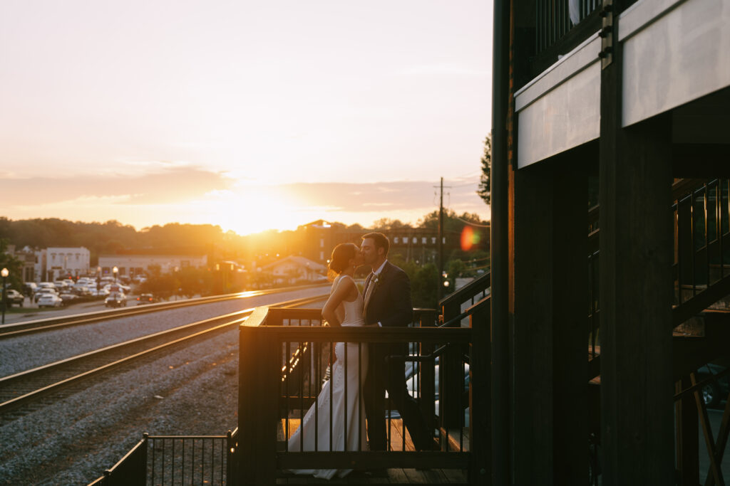 Bride and groom kissing during sunset at Cowan Historic Mill