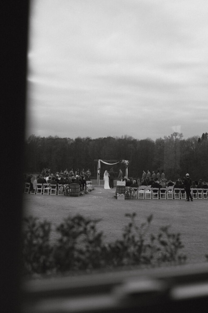 Faraway, black and white photo of a wedding ceremony at Grant Hill Farms.