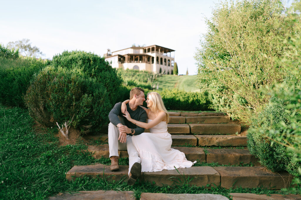 Couple sitting and cuddling on stone steps at Montaluce Vineyard and Winery