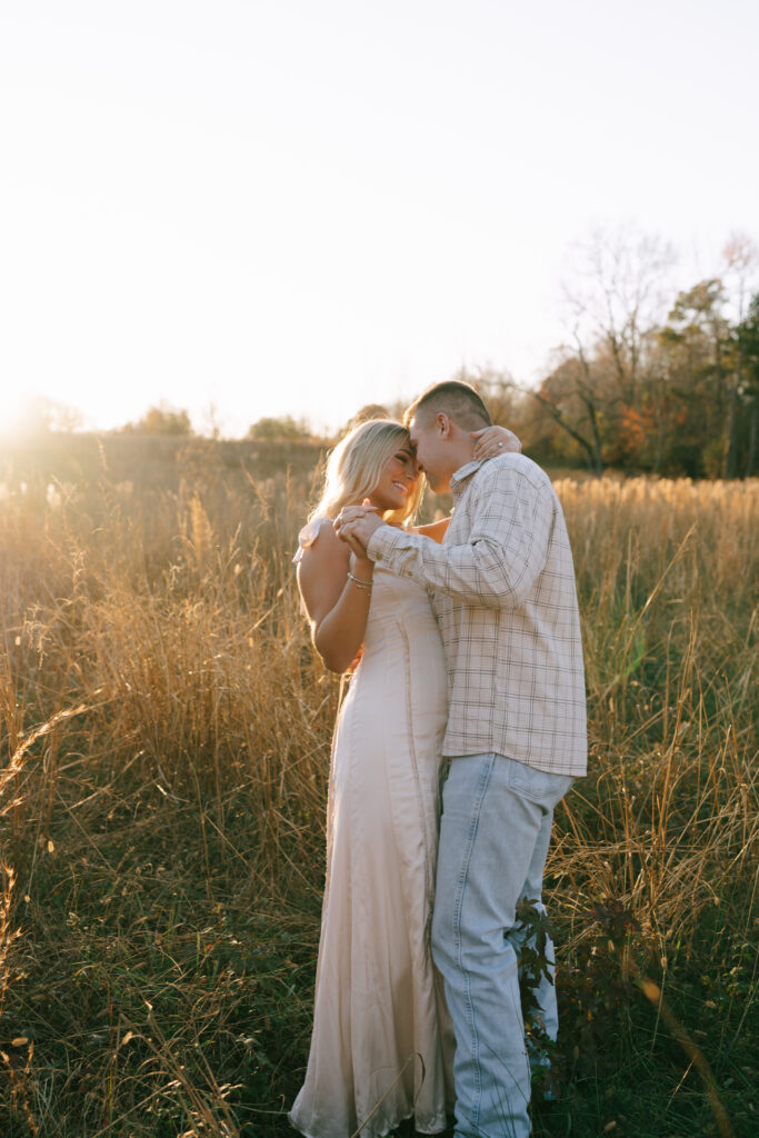 Couple embracing in a field of golden grass at Vaughters Farm