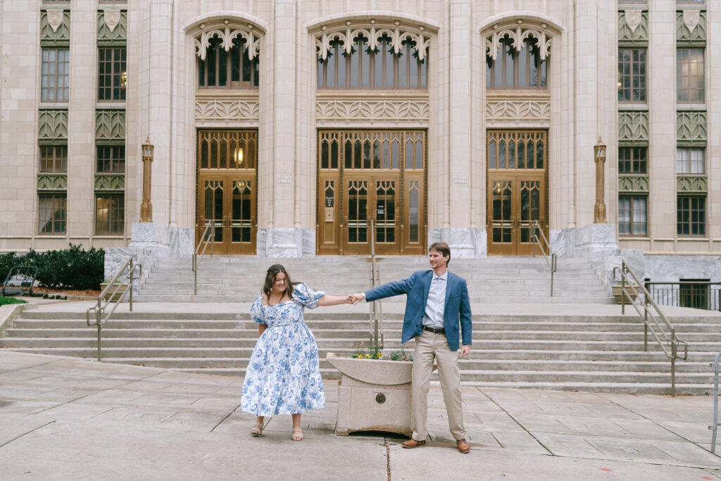 Couple holding hands in front of the Atlanta Capitol building