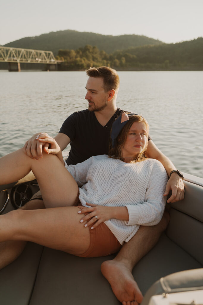 Couple lounging and cuddling on the open water in a boat