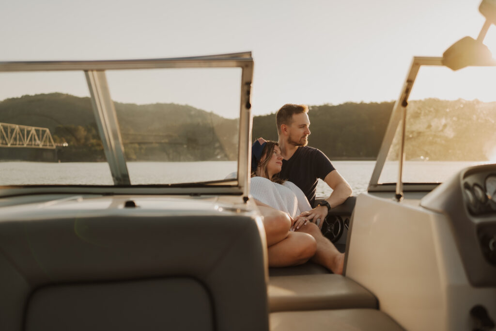 Couple sitting together in golden light on a boat