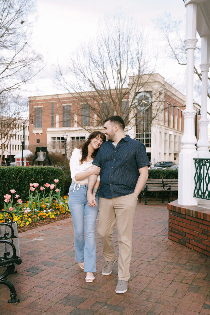 Couple walking and smiling at each other at The Marietta Square