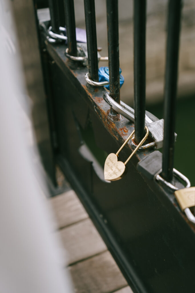 Gold, heart shaped lock locked on bridge in Piedmont Park.