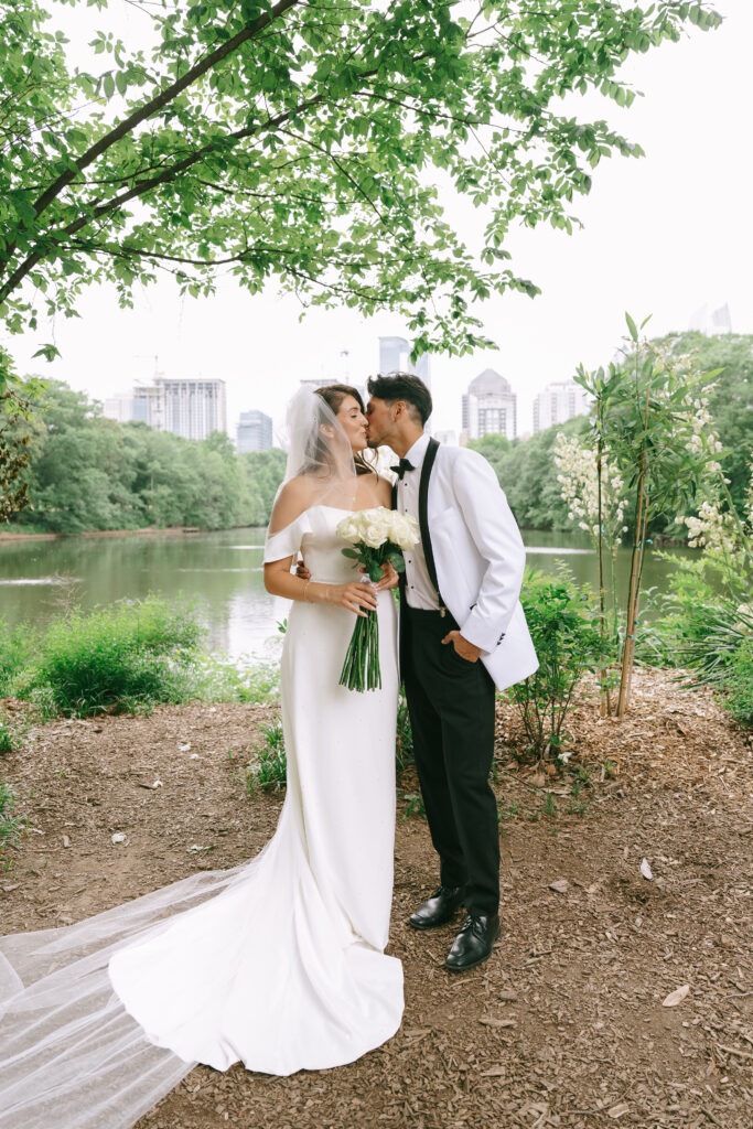 Bride and groom sharing a kiss in Piedmont Park.