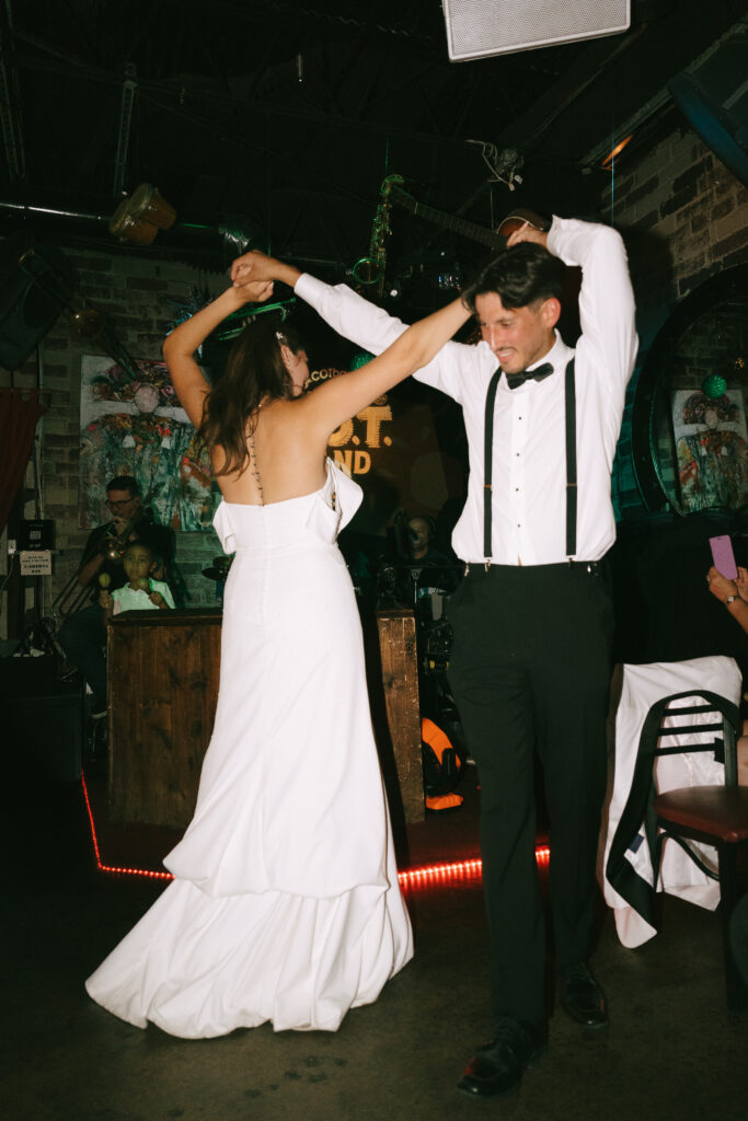 Bride and groom dancing at reception.