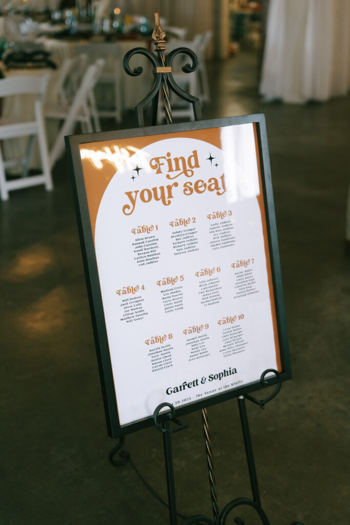 Orange "Find your seat" sign in a black frame.