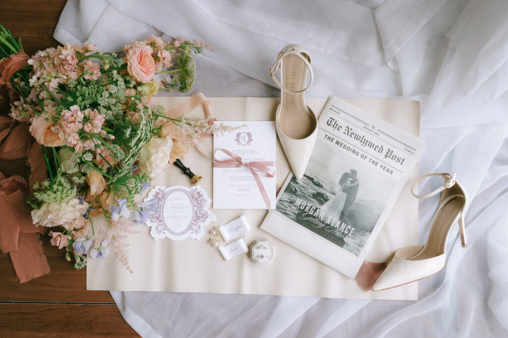 Wedding details with pink and green flowers, pointed toed heels, stationery, and a faux magazine featuring the bride and groom