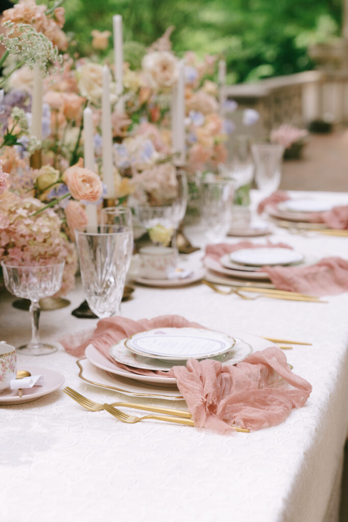 Bright springtime flowers lining a table with elegant gold accent plates