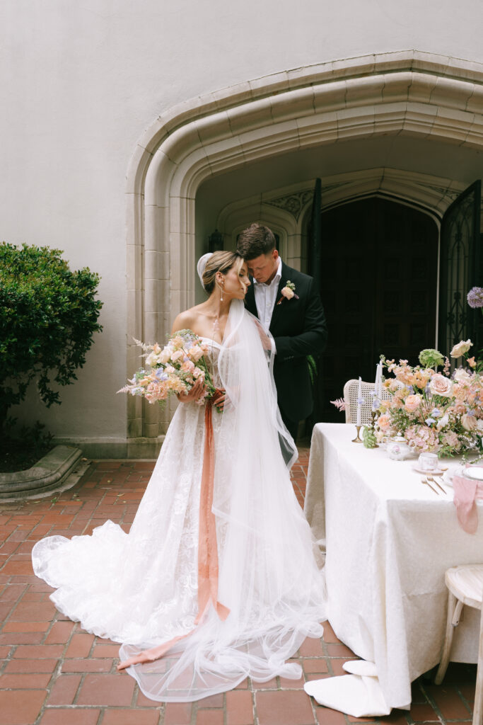 Bride and groom standing with foreheads pressed together